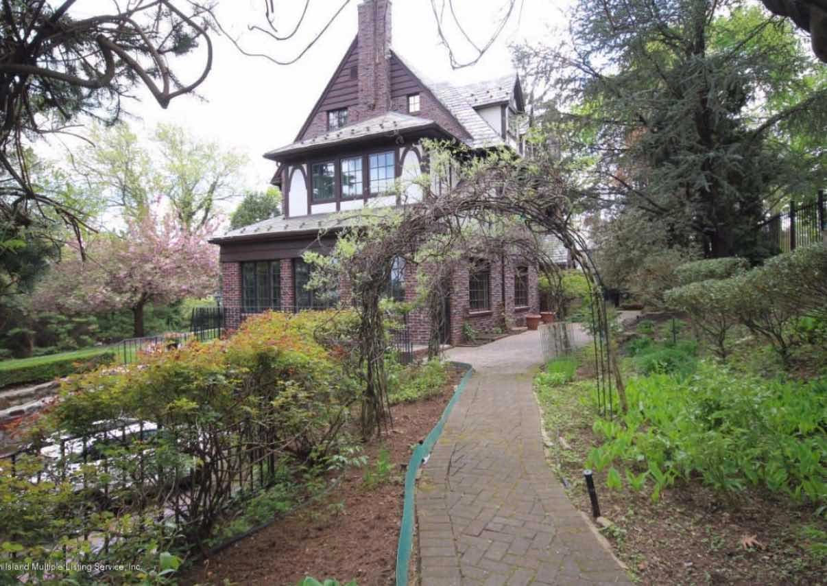 This secluded Staten Island mansion has a spooky stained-glass window in the shape of a spider web