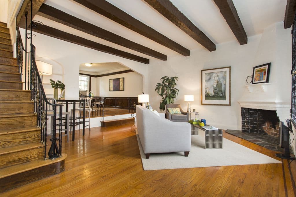 This Tudor Forest Hills townhouse has a fireplace, a back patio, and lots of elegant details