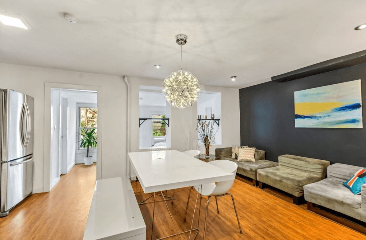 This Crown Heights townhouse comes with rental apartments and a yard that needs some TLC