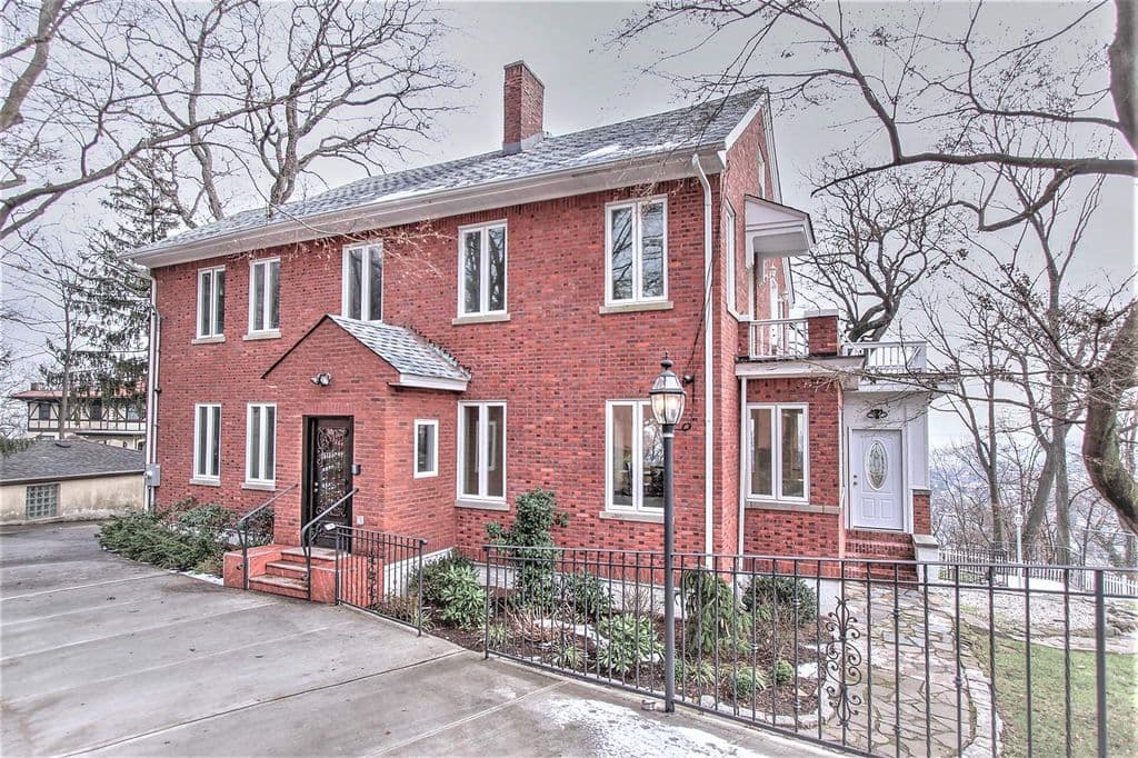 Soak up the view from this spacious Staten Island colonial with a pool