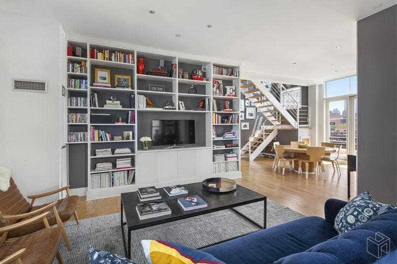 A Dumbo duplex with floor-to-ceiling bookshelves beckons your library