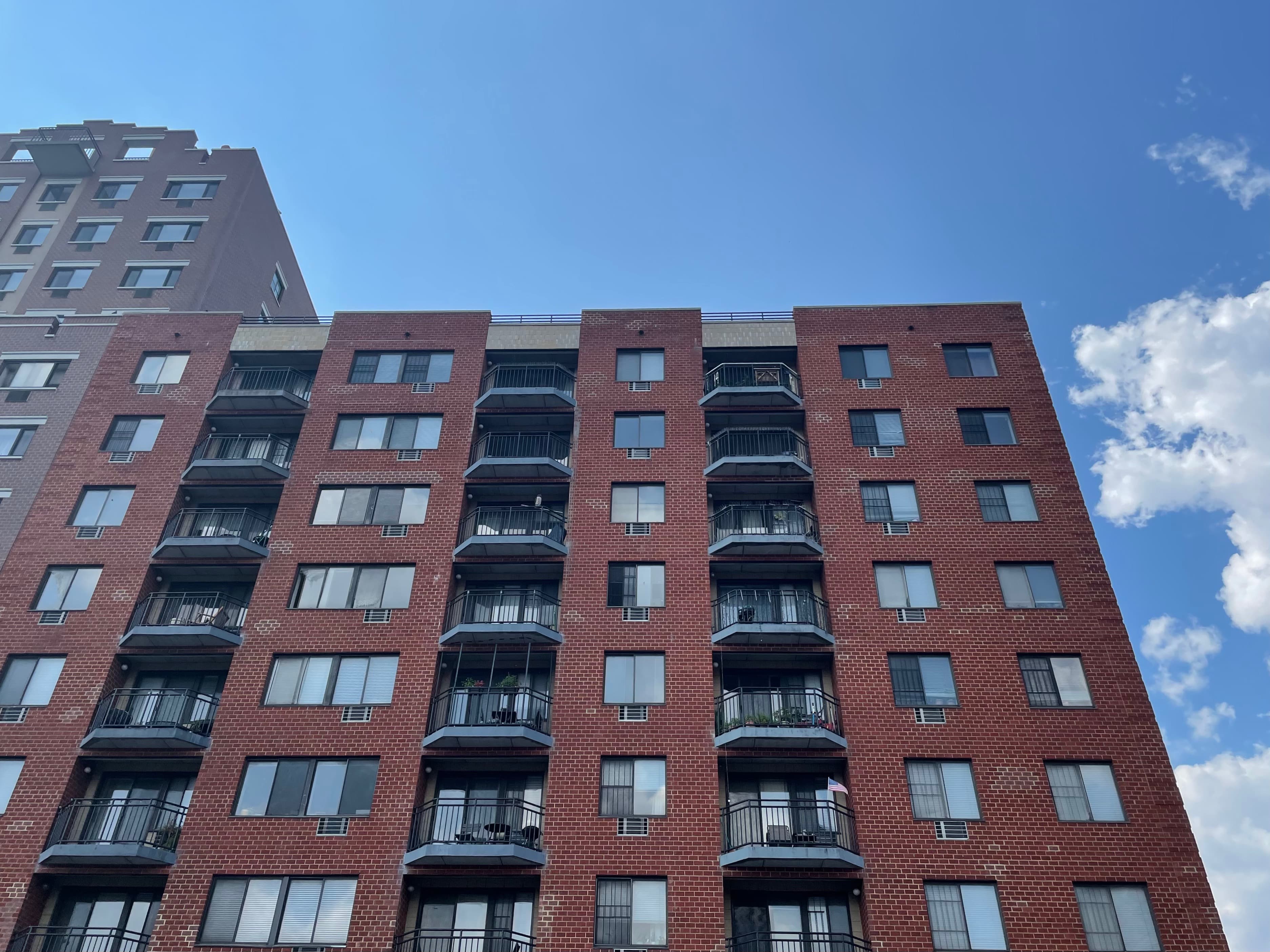 What are the pros and cons of living in a top-floor apartment in NYC?