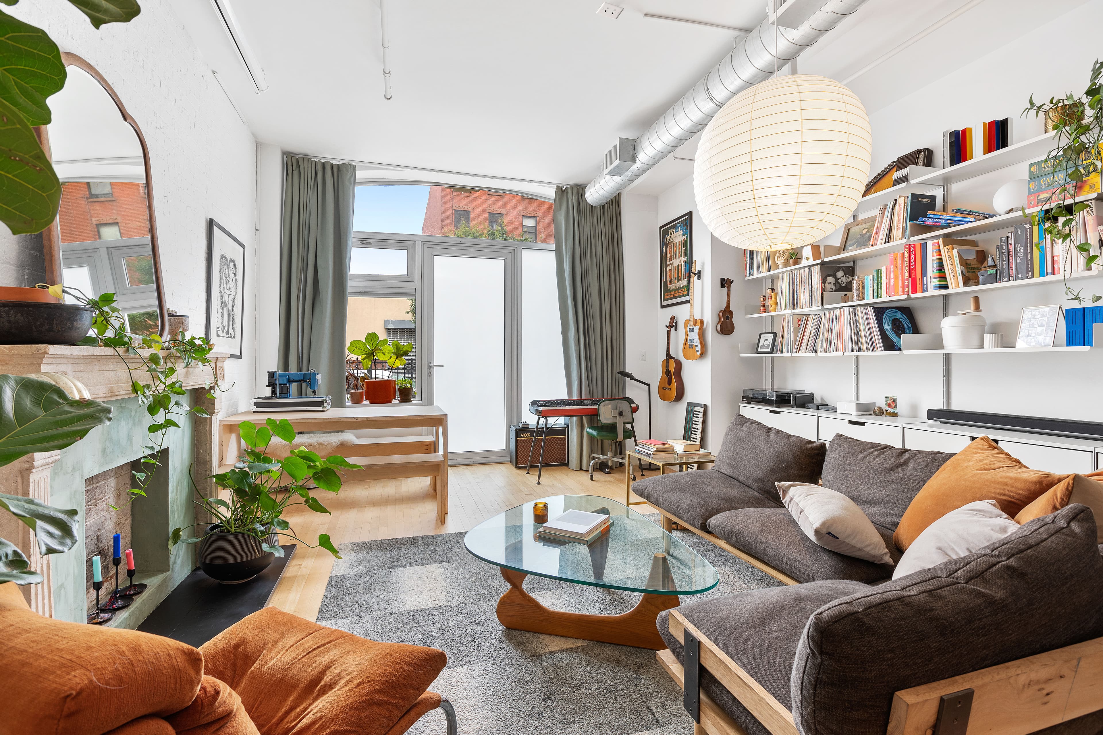 A Clinton Hill studio with a fireplace, storage, and separate sleeping area, for $875,000