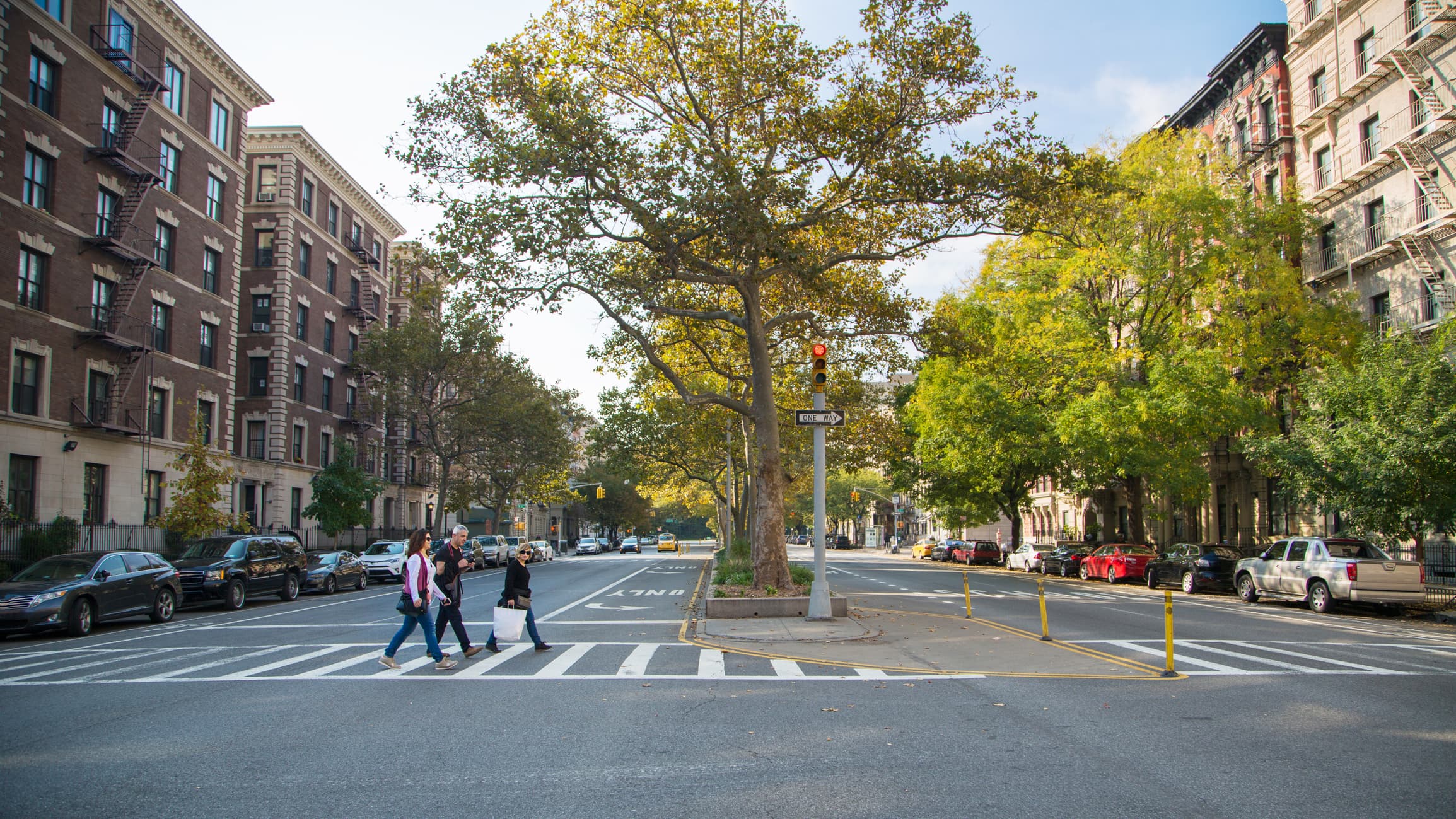 Shoppers walking in crosswalk Harlem, NYC