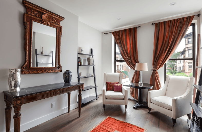 This fully renovated Crown Heights townhouse has a traditional facade and glass-walled rear