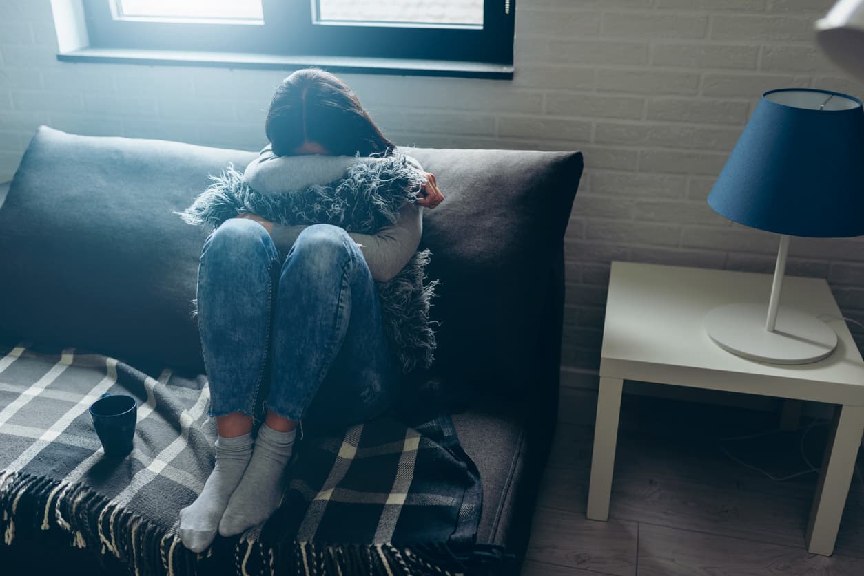 Distressed woman sitting in her apartment