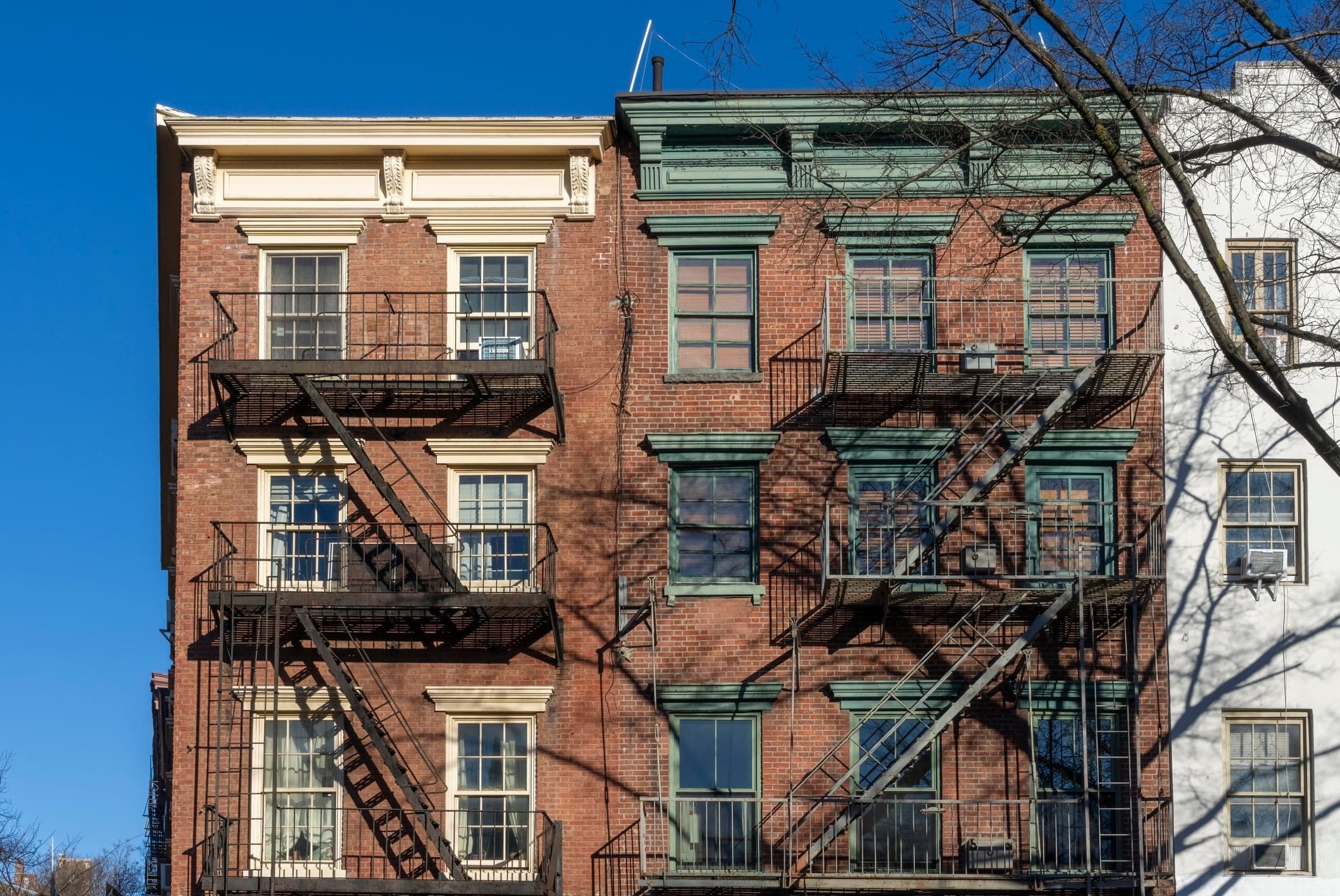 Classic exterior metal fire escapes on or near Greenwich Street in New York City.