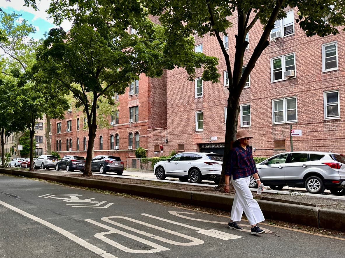 Woman walking down street in Jackson Heights