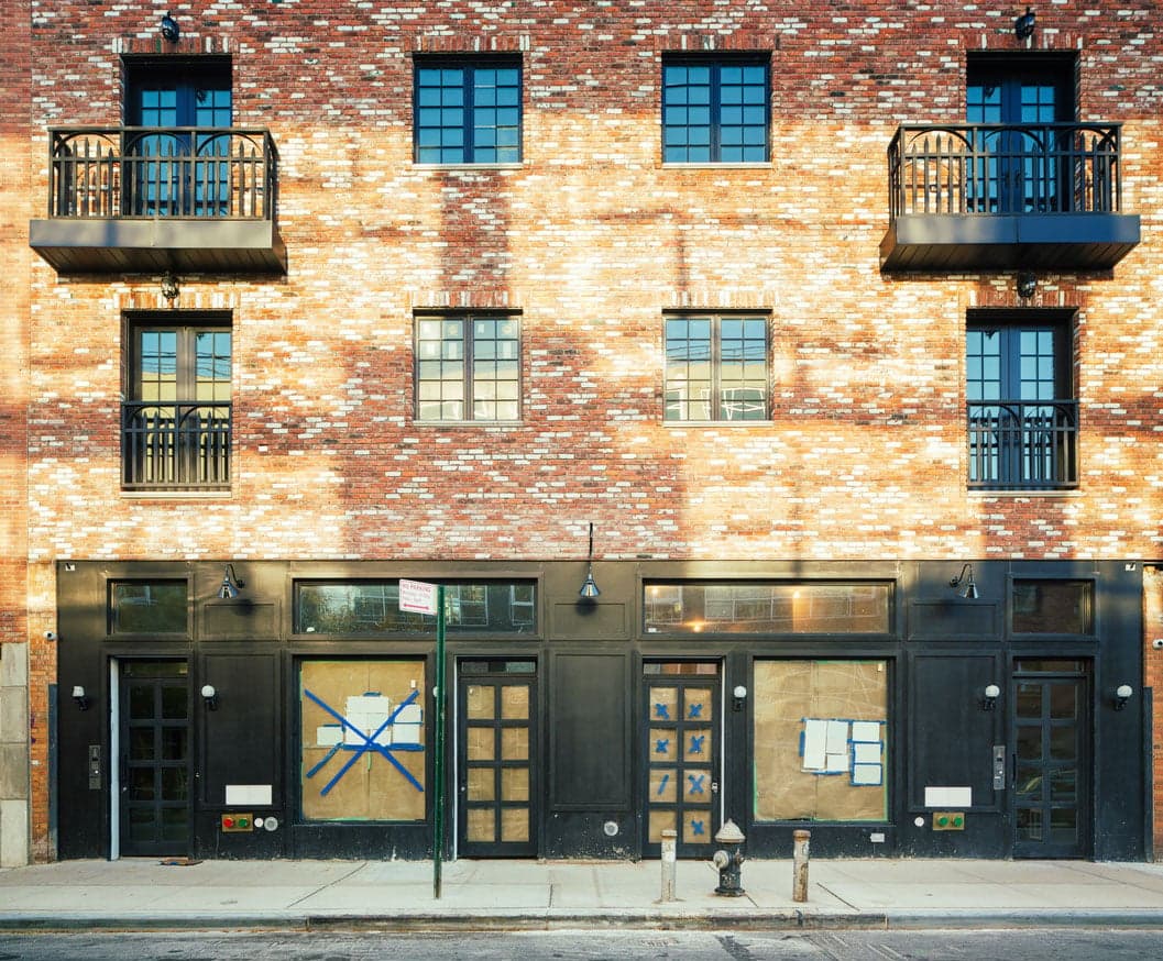 NYC has lots of empty stores. Why can't people live in them?